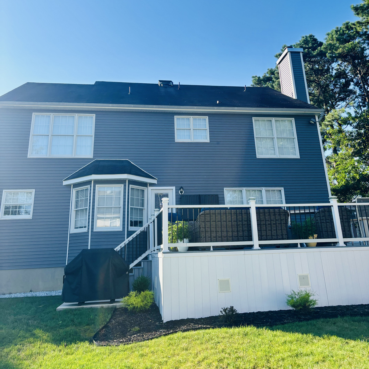 Completed roofing job on a gray Ocean County home with new shingles