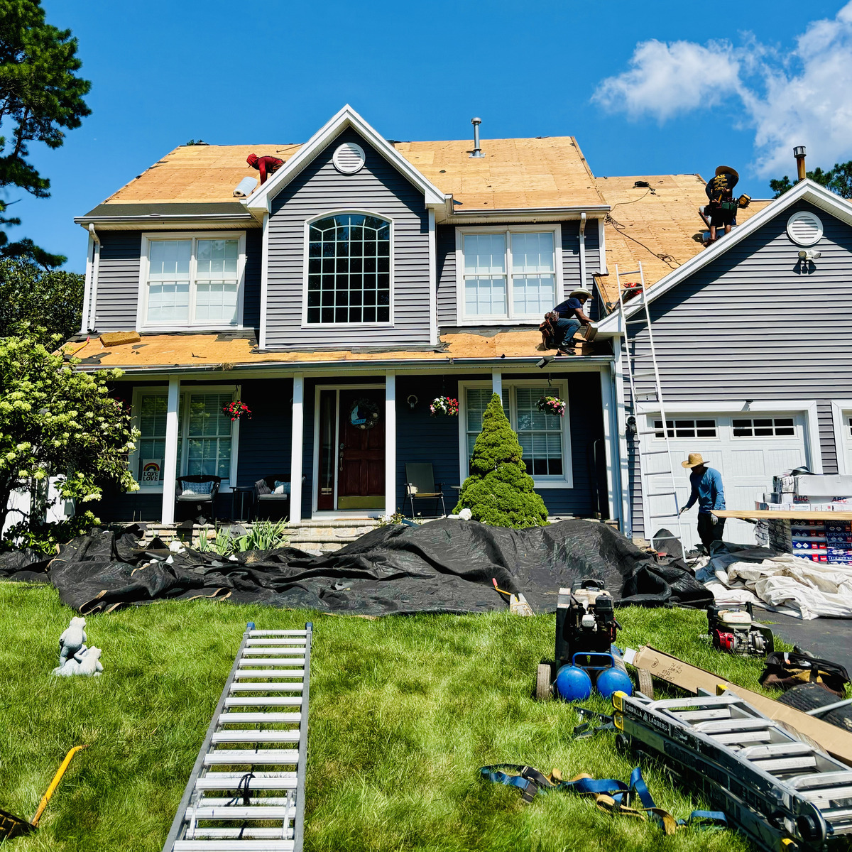 Roddy Roofing crew tearing off and re-decking a two-story Ocean County home