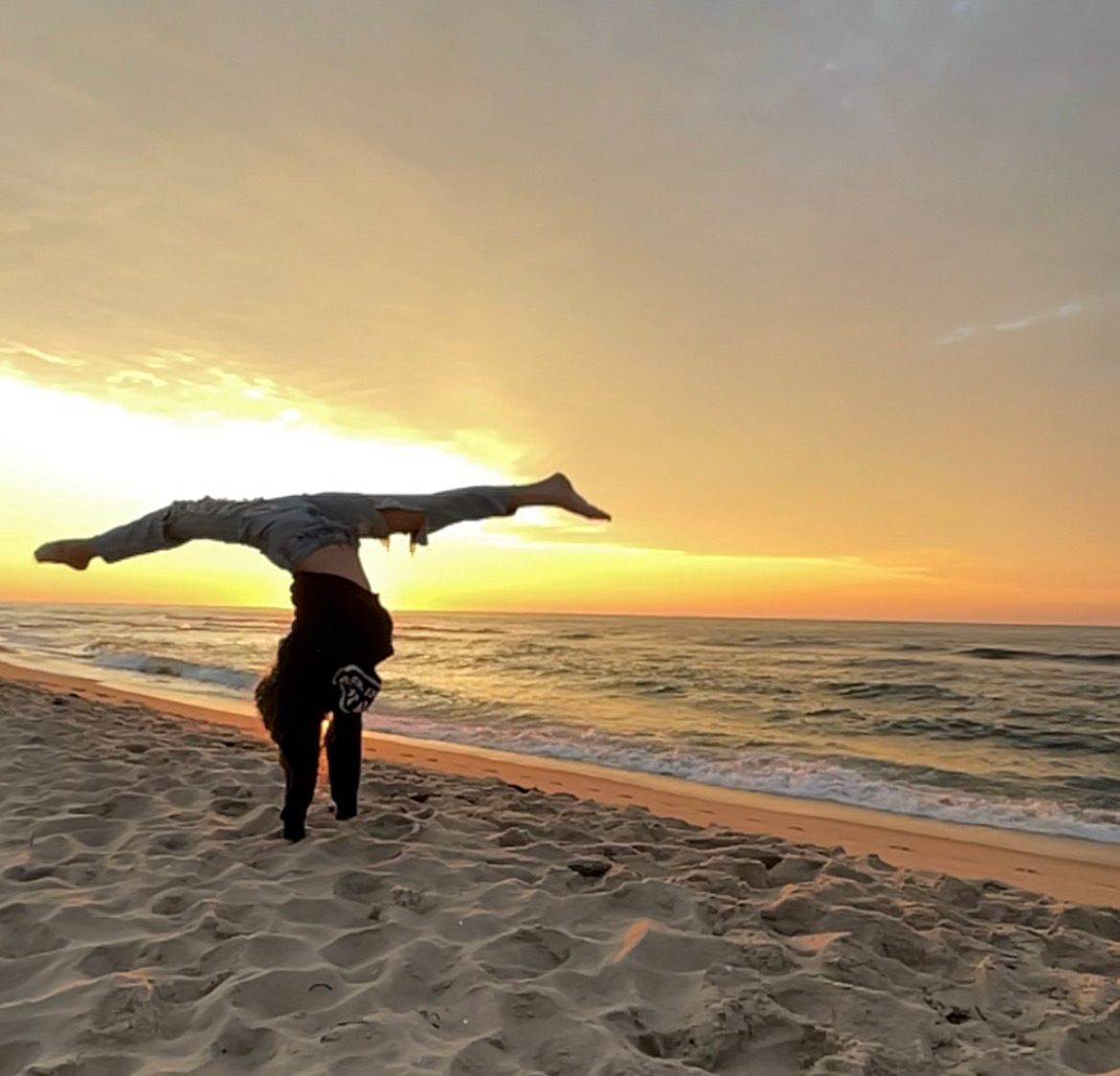 Handstand on the beach at sunset